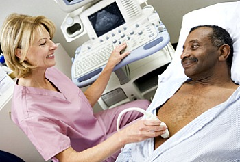Man with AAA lying in bed under the care of a doctor during the screening process